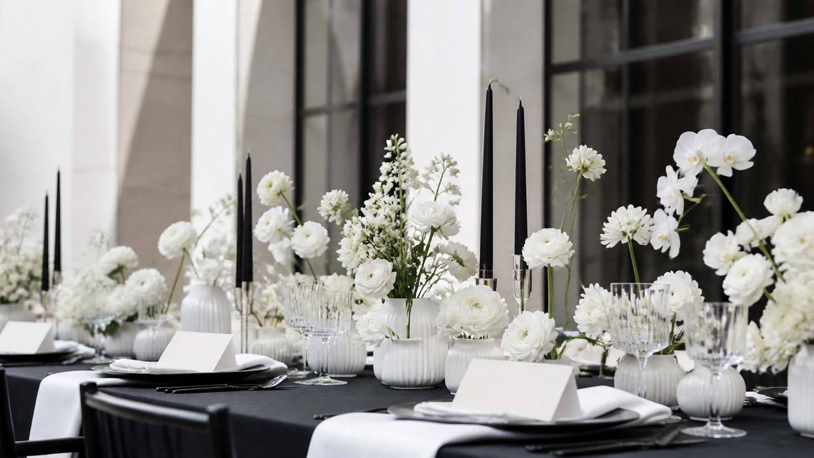 Moderner Hochzeitstisch in Schwarz und Weiß mit weißen Blumen